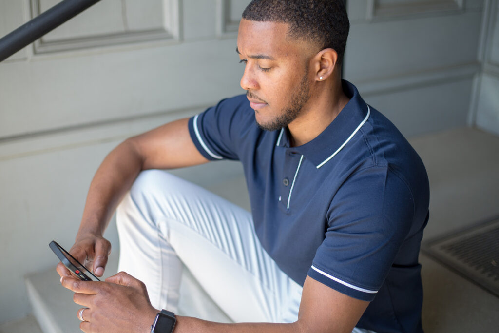 Job seeker checking design job listings on mobile while taking a break